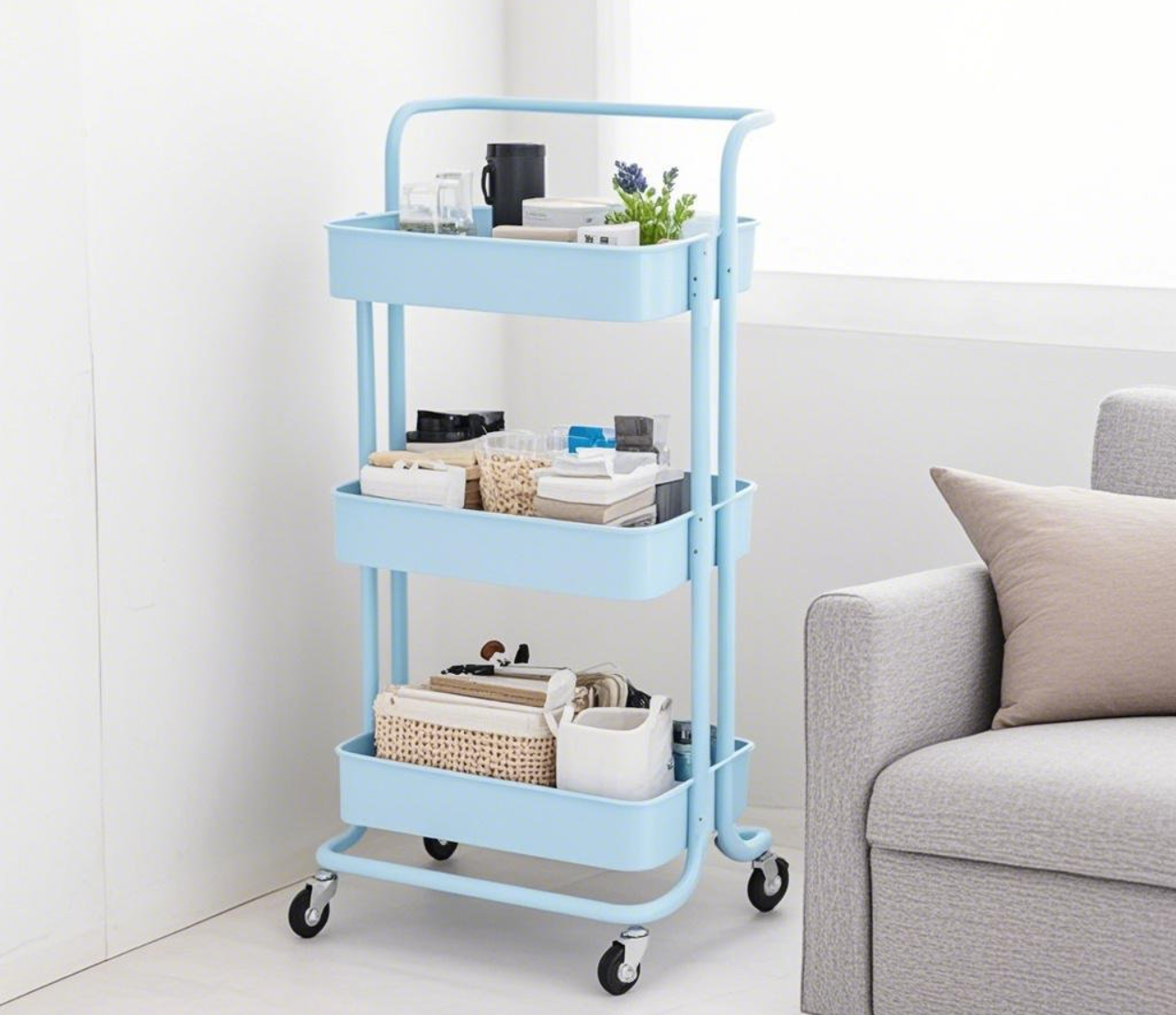 Light - blue three - tier cart with items. Голубая трехъярусная тележка с товарами.
