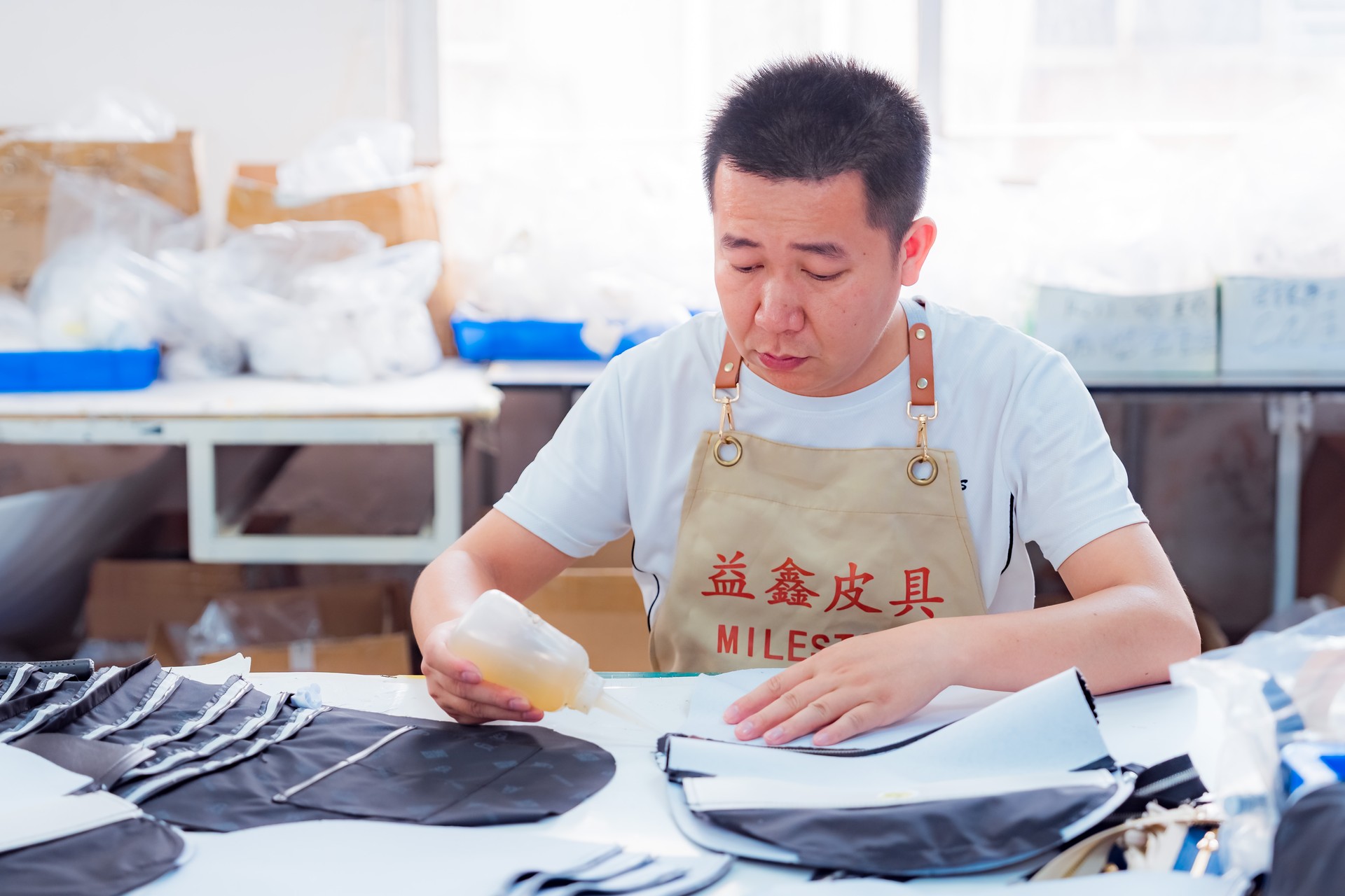Artisan assembling PU bag in factory